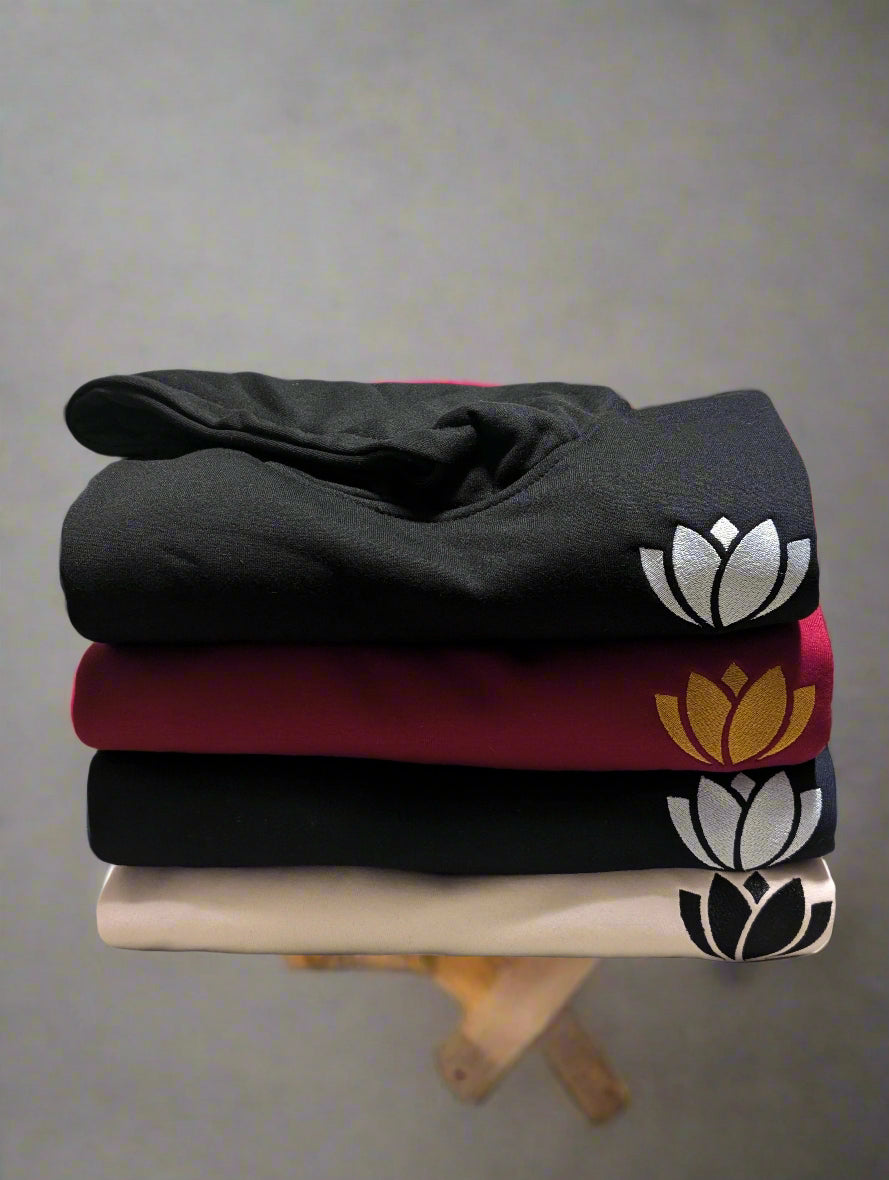 Stack of folded cloths with floral patterns on a light-colored surface.