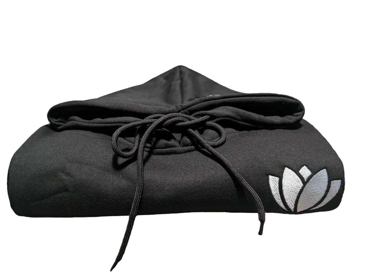 Black hoodie with a logo on a table in a casual setting