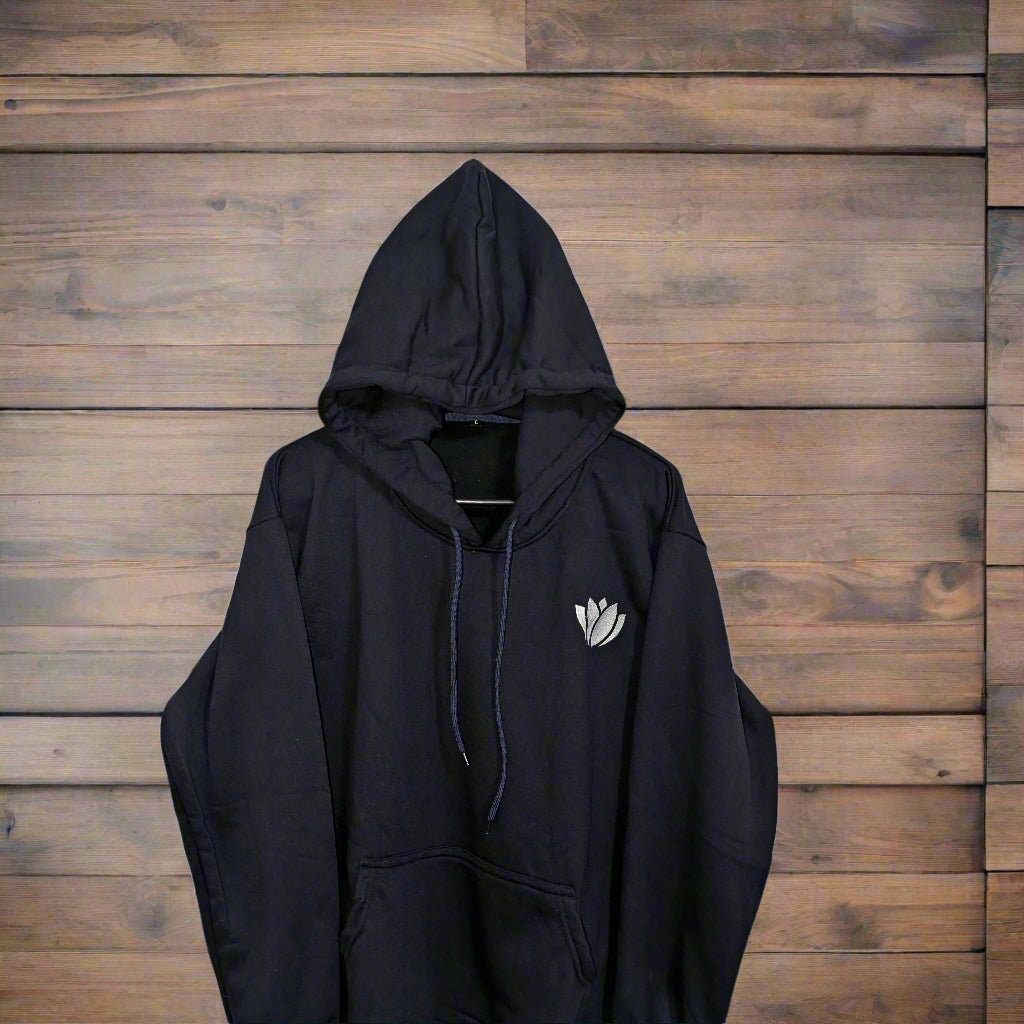 Black hoodie with a white logo on a beige background