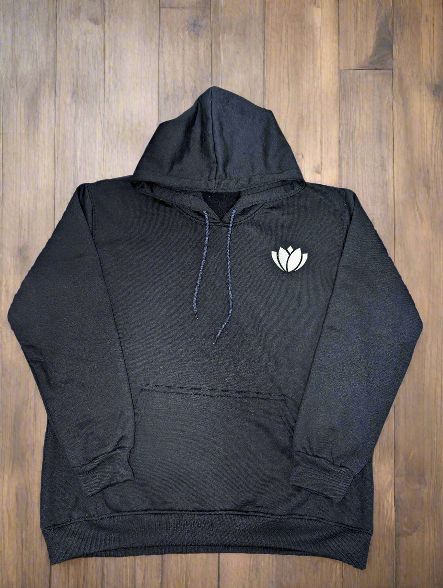 Black hoodie with a white logo on a colorful patterned fabric background