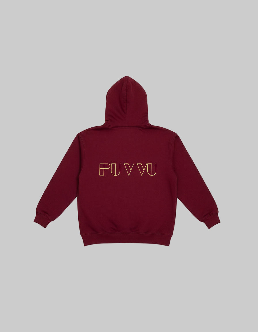Red hoodie with 'PU VVU' text on the back, hanging against a beige wall.